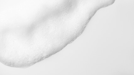 Foam border design, white foam on white background, close up. Liquid soap, shampoo bubbles, Foam bubbles backdrop. Soap sud macro structure. Clean, cleaning, washing. Top view
