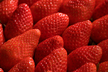 Strawberry, fresh ripe strawberries background close up. Organic Vegetarian healthy food backdrop, macro shot. Top view, flat lay. 