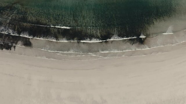 Top View Of Calm Waves Over Yttersand Beach In Lofoten, Norway. Aerial Slow Motion Shot