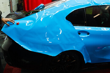 Detailers expertly apply wrap to fit contours and ensures smooth, flawless wrap alignment. Applying...