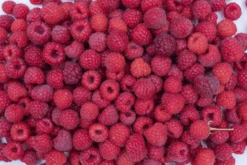 Top view of red raspberries with black currents. Natural mixed berries background.