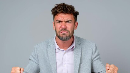 Man in a suit is throwing his hands up in the air and yelling. He looks angry and frustrated - Powered by Adobe