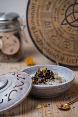 Close-up of an incense bowl with aromatic herbs and frankincense burning on hot charcoal. Rising smoke creates a peaceful and meditative atmosphere.