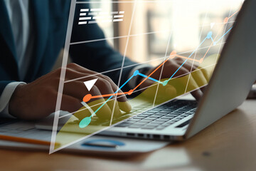 Business professional analyzing financial data on laptop with graphs and charts, modern workspace, focus on hands and technology, financial analysis concept