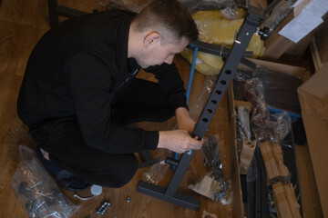 Assembling fitness equipment indoors to create a home gym for health and convenient workouts.
