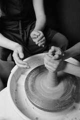 Close-up of hands shaping clay on pottery wheel in studio Creative ceramic art and mindful craft