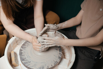 Close-up of hands shaping clay on pottery wheel in studio Creative ceramic art and mindful craft