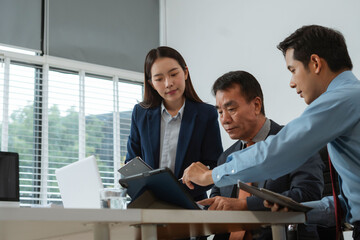 Professional business team meeting with consultant and project planning charts.