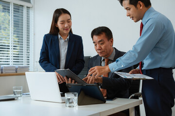 Professional business team meeting with consultant and project planning charts.