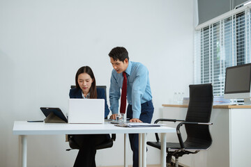Business team analyzing documents, graphs, and data with a laptop, tablet, and smartphone. Collaboration, strategy, and success.