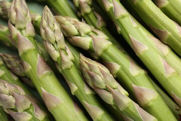 Many fresh raw asparagus spears as background, closeup