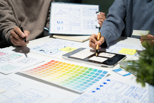 Creative digital development agency. developer team brainstorming on their project with laptop, smartphone and digital tablet. - Powered by Adobe