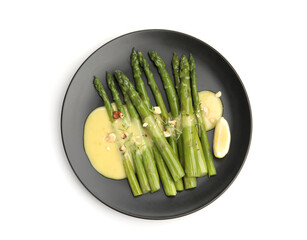 Tasty cooked asparagus with lemon and sauce isolated on white, top view