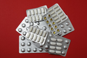 blisters with pills, pills, on a red background