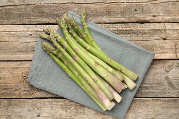 Fresh raw asparagus spears on wooden table, top view