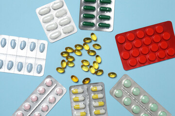 blisters of tablets on a blue background