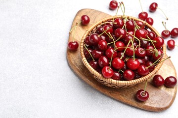 Fresh ripe cherries on light table. Space for text