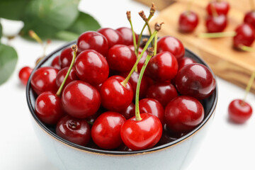 Fresh ripe cherries on white wooden table, closeup