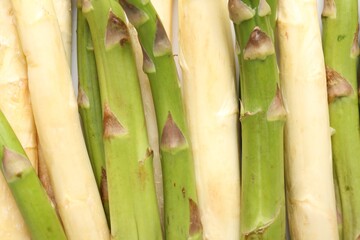 Fototapeta premium Different raw asparagus spears as background, top view