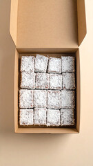 A delicious assortment of brownies in a cardboard box, perfect for sharing or indulging in a sweet treat.