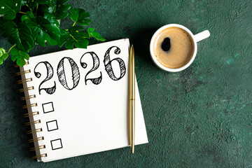 New year resolutions 2026 on desk. 2026 resolutions list with notebook, coffee cup on table. Goals,...