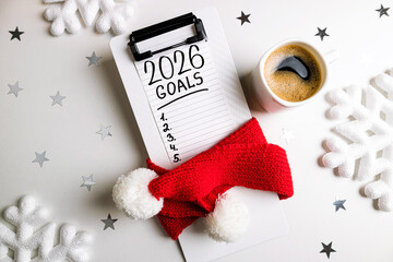 New year resolutions 2026 on desk. 2026 resolutions list with notebook, coffee cup on table. Goals,...