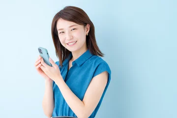 Fotobehang スマホ　女性　ブルーバック © naka