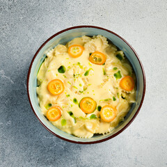Italian farfalle pasta with cheese and kumquat. In a plate. Close up.