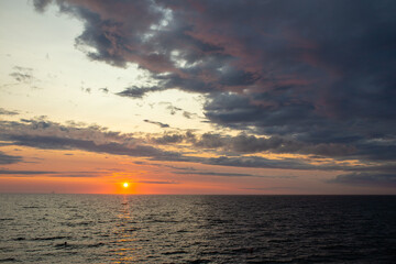 beautiful sunset in cloudy weather with the baltic sea in the background