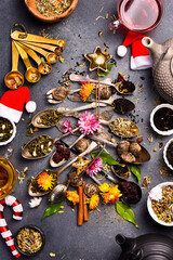 Tea arrangement in the shape of a Christmas tree. Different types of tea in spoons. Flat lay. On a...