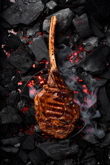 Juicy Prime Tomahawk steak on the grill, close-up. Black Angus steak. On charcoal. Top view.