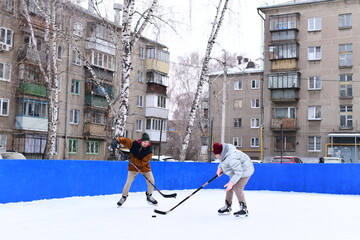 People skate and play ice hockey in the yard