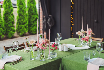 Elegant wedding reception setup featuring floral centerpieces and soft candle lighting in a cozy...