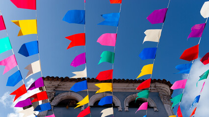 Obraz premium Colorful plastic pennants for decoration against a blue sky.