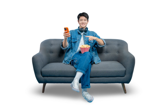 PNG,A smiling young man points at his popcorn while holding a phone, perfect for food delivery app or movie snack concepts.
 - Powered by Adobe