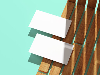 Minimalistic business card resting on a wooden surface with shadows.