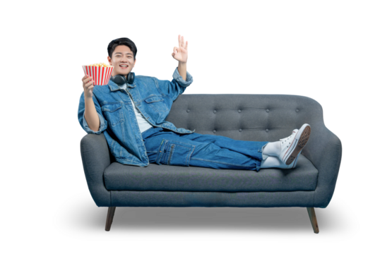 PNG,A man relaxing on a sofa with popcorn gives an "OK" sign, indicating he's enjoying a perfect movie or show.
 - Powered by Adobe