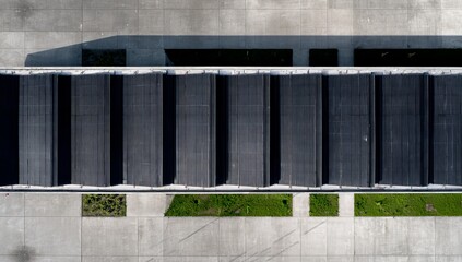 a wall on the side of a building. a large building with a lot of windows. a brick wall with a building behind it