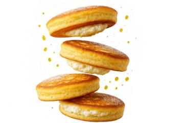 Stack of fluffy mini pancakes with cream filling, isolated on transparent background.