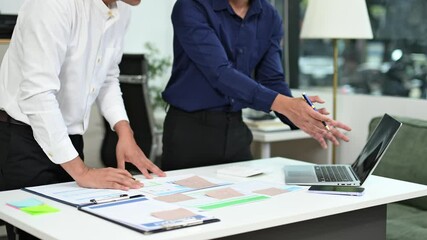 Business documents on office table with smart phone and calculator digital tablet and graph business with social network diagram and two colleagues discussing data working in the office

 - Powered by Adobe