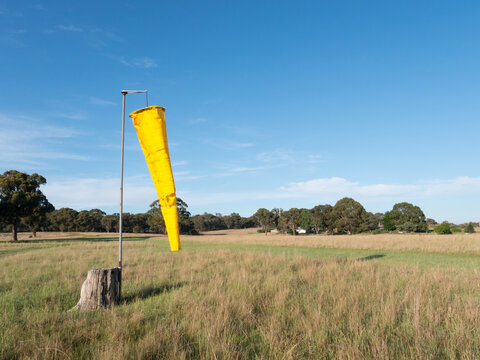 Yellow windsock on a country airstrip
