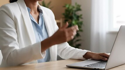 Businesswoman in virtual job interview talking on video call. Black female professional confident during online meeting with laptop at desk. - Powered by Adobe