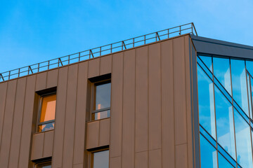 stylish black house loft frame work building exterior from below perspective with clear blue sky background view