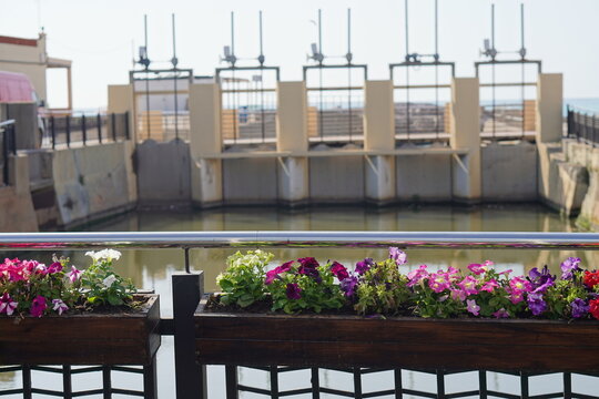 flower-decorated bridge over the canal with dam and gorge in Nules