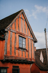 A red house with a slanted roof and a window