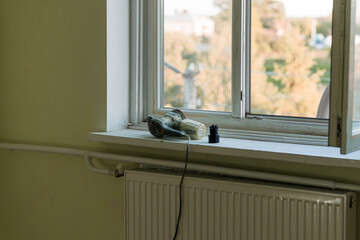 Vintage Camera on Window Sill During Home Renovation: Yellow Interior with Green View, Power Tool,...