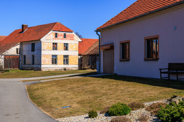 Rural village scene with red roof houses on sunny day