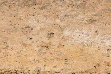 Weathered old stone wall texture with natural patterns and color variations