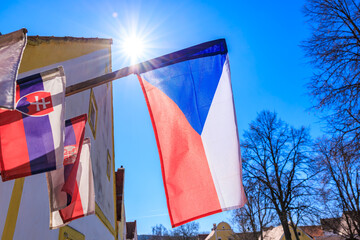 Czech flag waving under bright sunlight in picturesque street scene