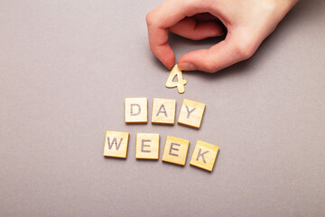 Top view of man hand putting word four day week making by wooden cubes